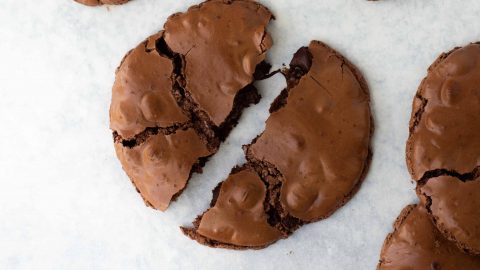 chocolate cookie broken into two on marble surface