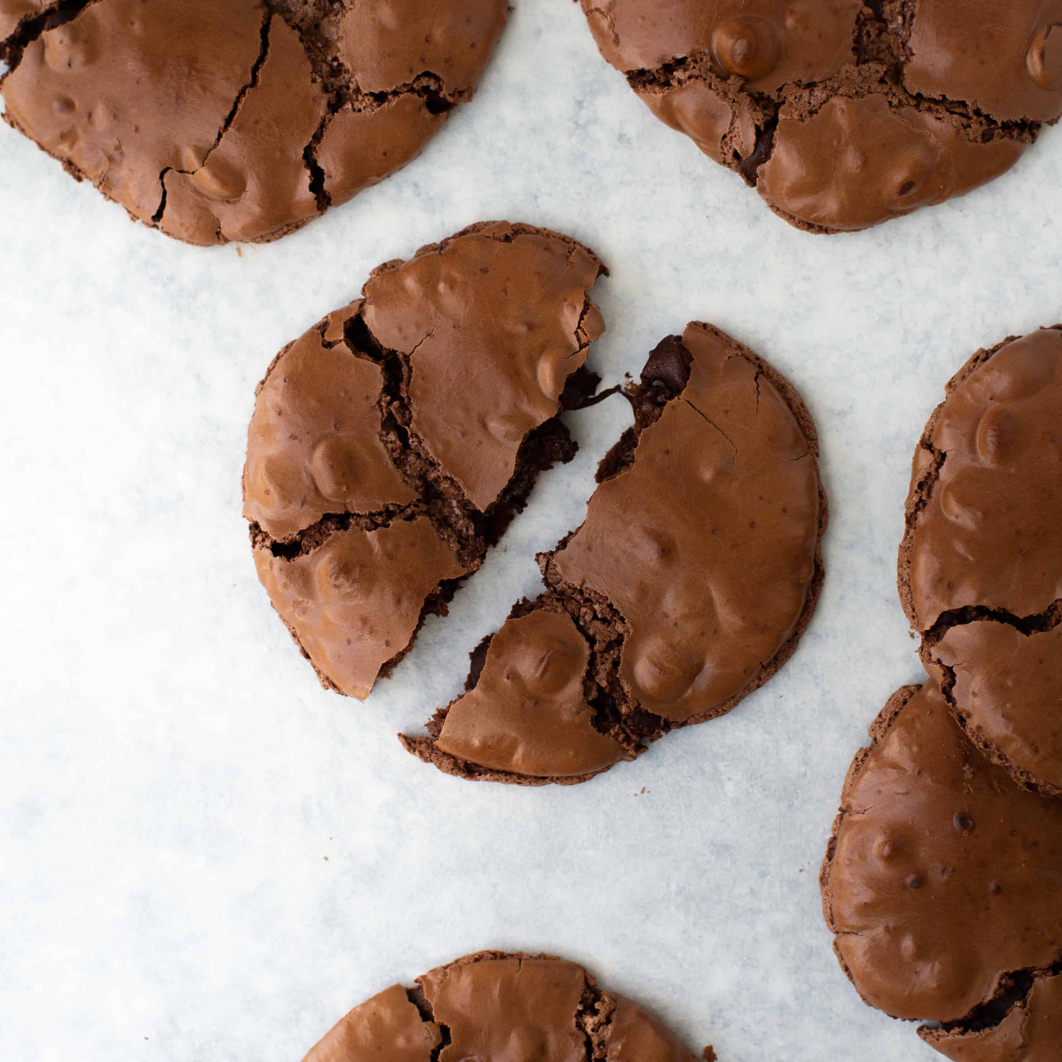 chocolate cookie broken into two on marble surface