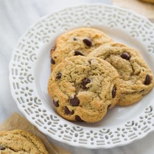 three chocolate chip cookies on a white plate