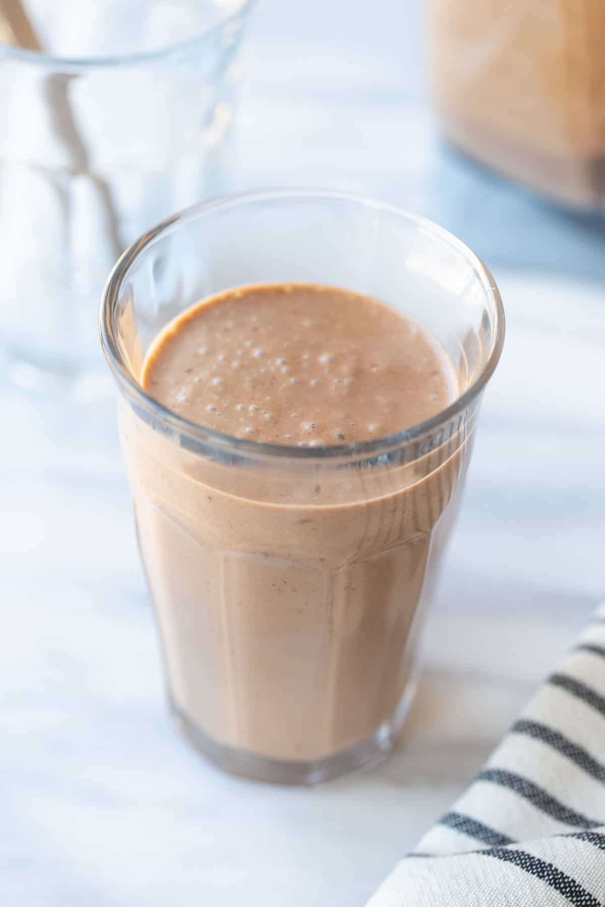 thick and creamy chocolate banana smoothie in a tall glass