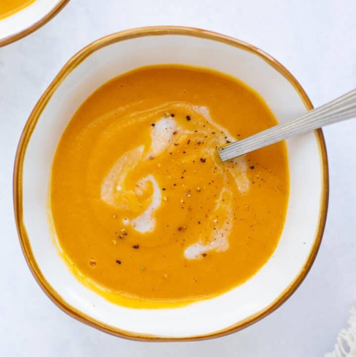 spoon in bowl of creamy sweet potato soup
