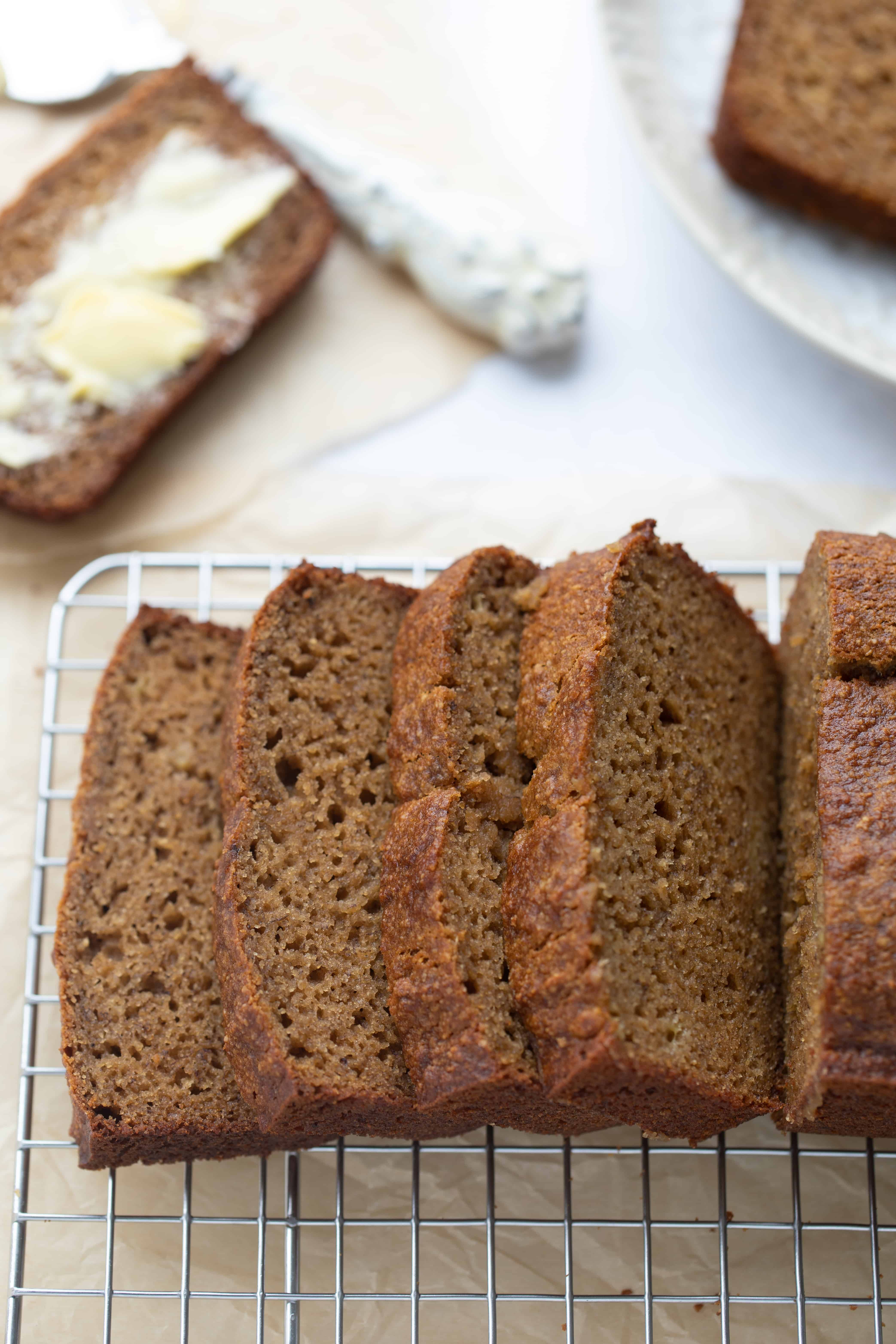 slices of moist paleo banana bread on wire cooling rack