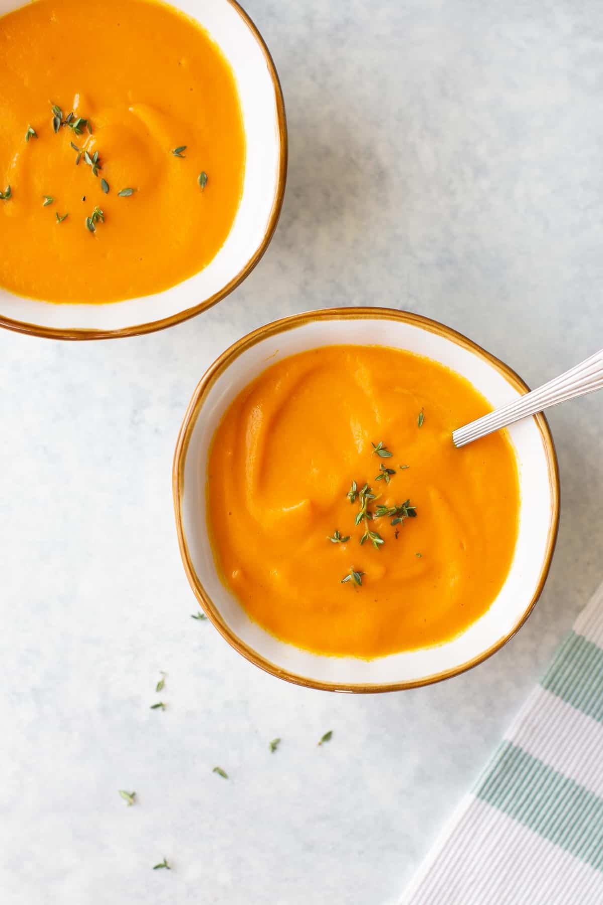 two bowls of homemade carrot ginger soup