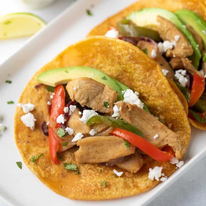 easy chicken fajitas with cheese and avocado slices