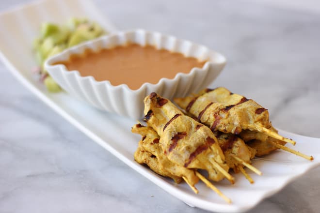 Side angle view of Chicken Satay with Peanut Dipping Sauce
