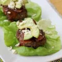 Beef patty with avocado on a leaf of butter lettuce