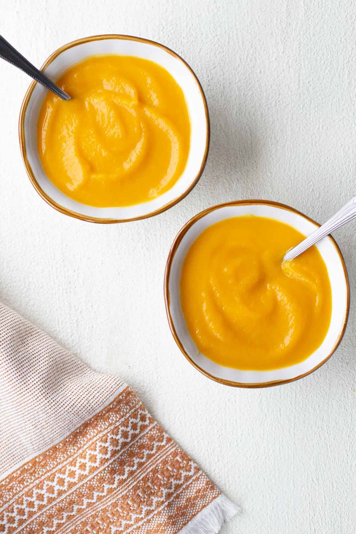 two bowls of butternut squash soup