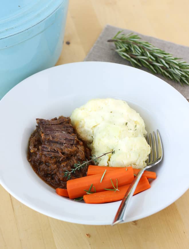 Beef mashed potatoes and carrots on a white plate
