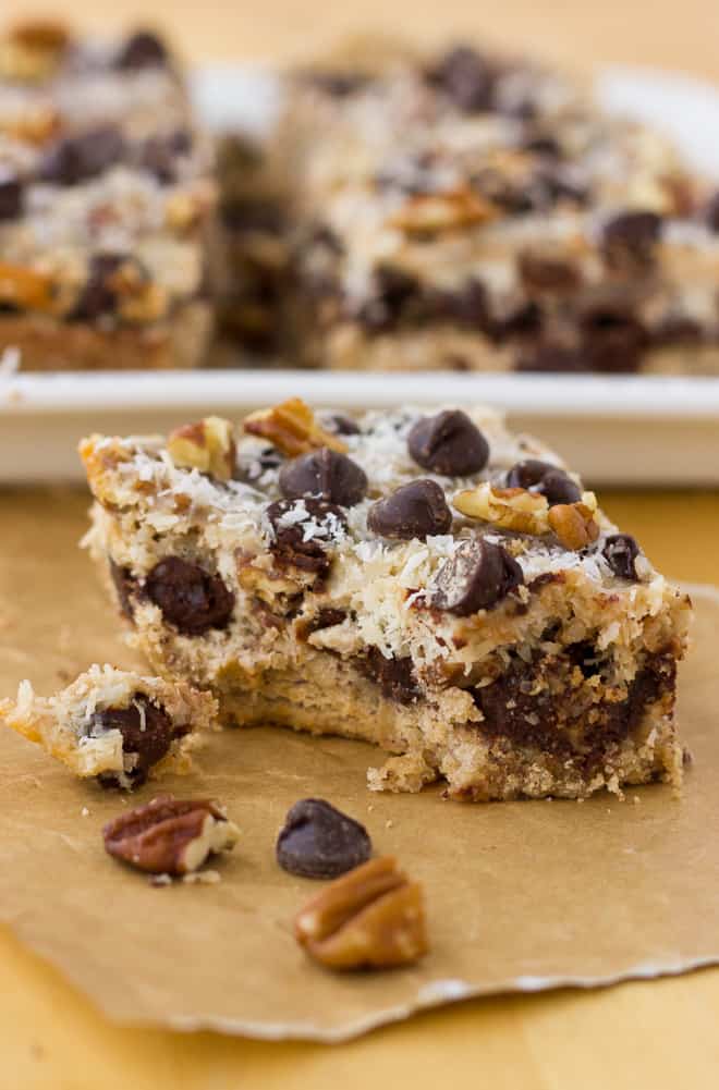 Cookie bar with a bite taken out of it on parchment paper