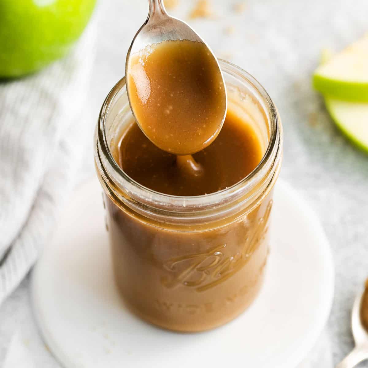 Caramel in a jar with a spoon in it