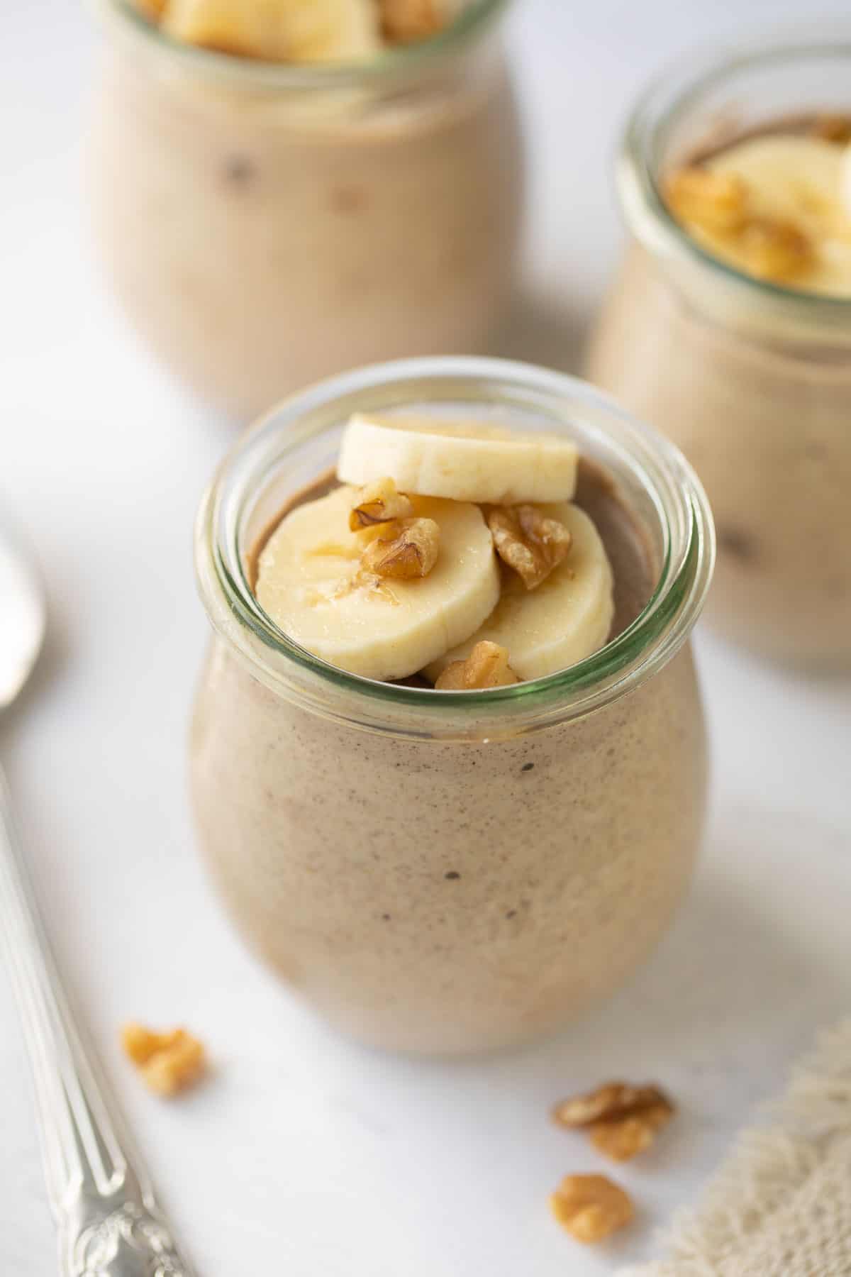 overhead image shows glass weck jars filled with banana chia pudding