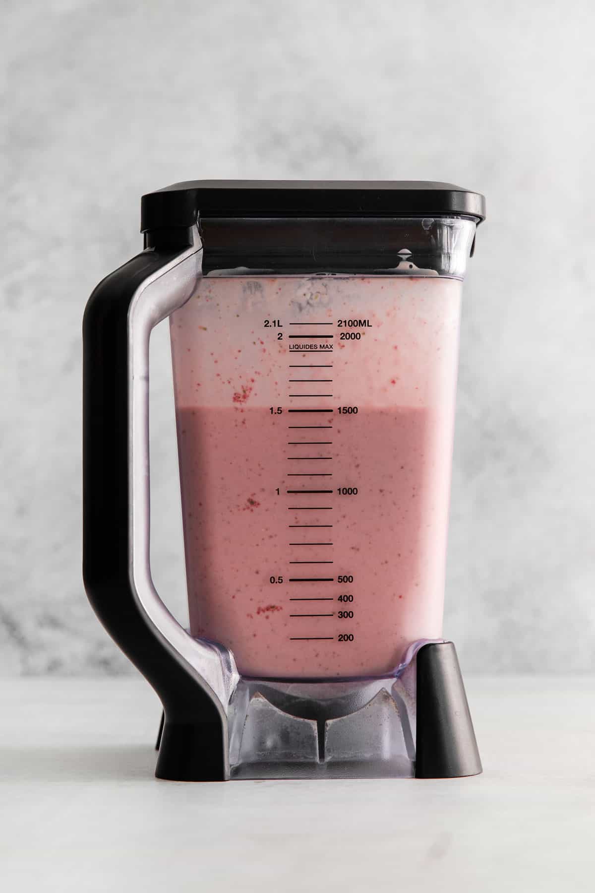 Strawberry spinach smoothie in a blender