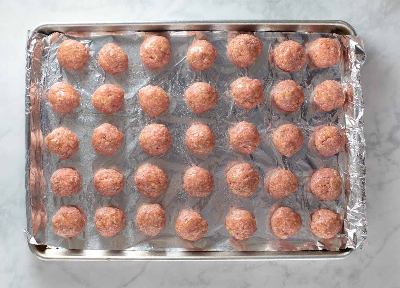 meatballs shaped on baking pan