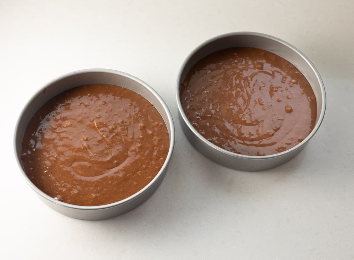 German chocolate cake batter in two round pans