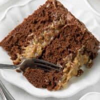 Slice of German chocolate cake with a fork taking a bite
