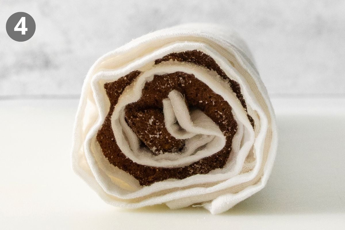 A white cloth rolled up with a dark, textured filling inside, labeled with the number four.