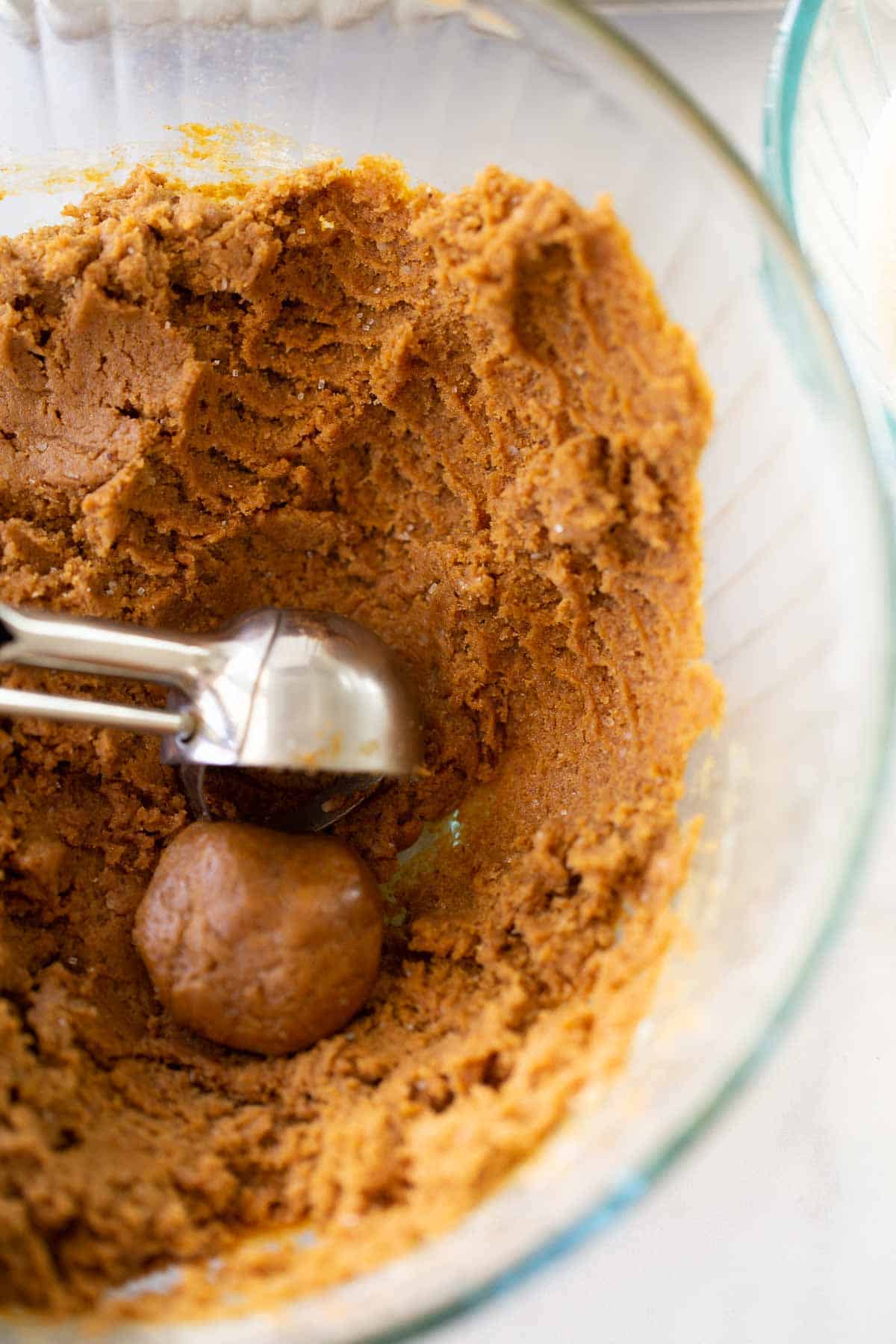 molasses cookie dough with cookie dough scoop