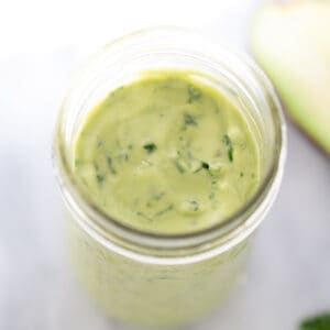 avocado dressing in mason jar with marble background
