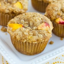 close up shot of peach muffin on white plate