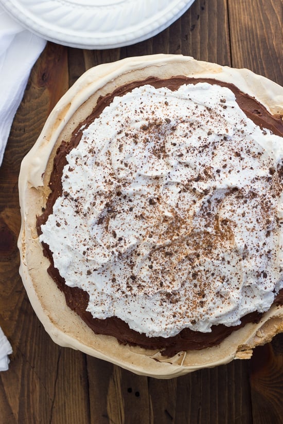Chocolate Angel Pie! A crisp meringue crust filled with chocolate-truffle-like filling, then topped with pillowy whipped cream. Gluten-free, dairy-free and made with pantry ingredients.