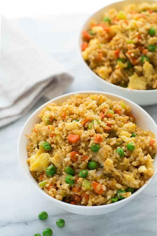 50/50 Cauli-Brown Rice Fried Rice! An easy fried rice made of 1/2 cooked brown rice and 1/2 cauliflower rice. One of my go-to healthy dinners! Easy, kid-friendly, yummy.
