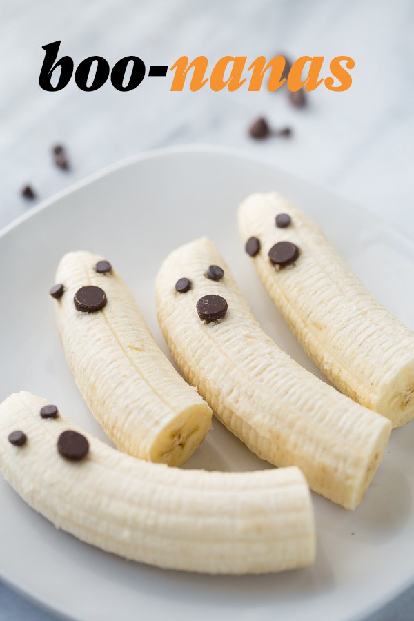 bananas with chocolate chips on white plate with marble background