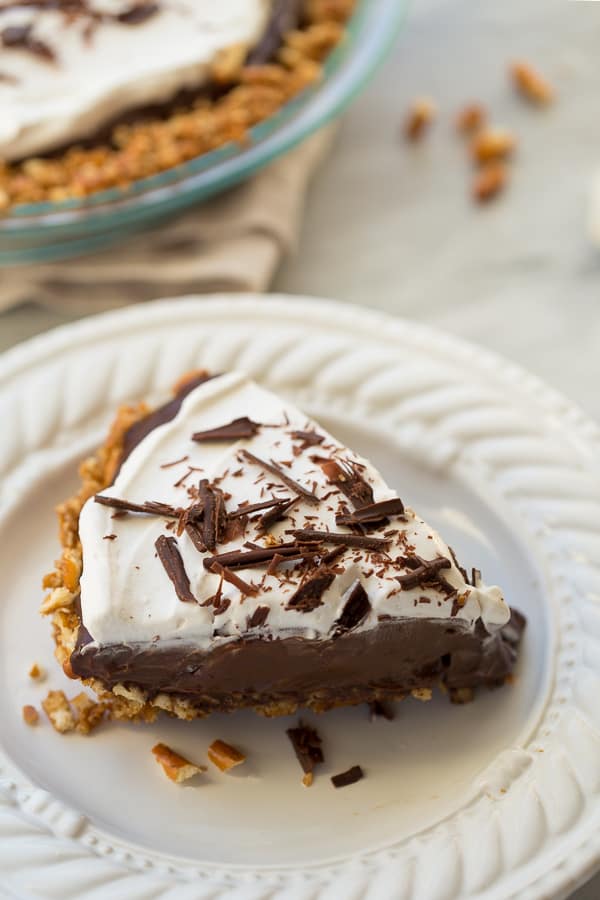 gluten-free vegan chocolate pie on white plate with shaved chocolate