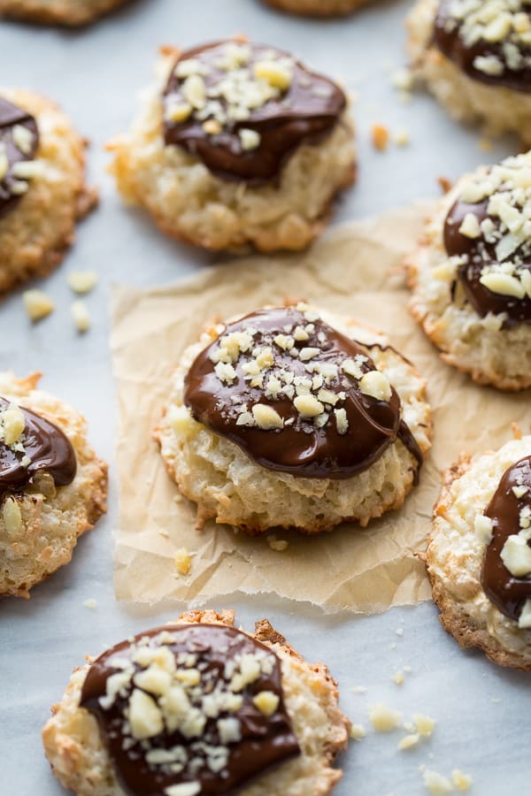 coconut cookies on marble background topped with chocolate and macadamia nuts