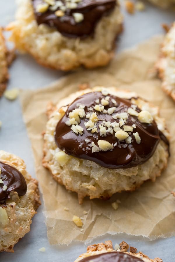 close up shot of coconut cookie topped with chocolate and macadamia nuts