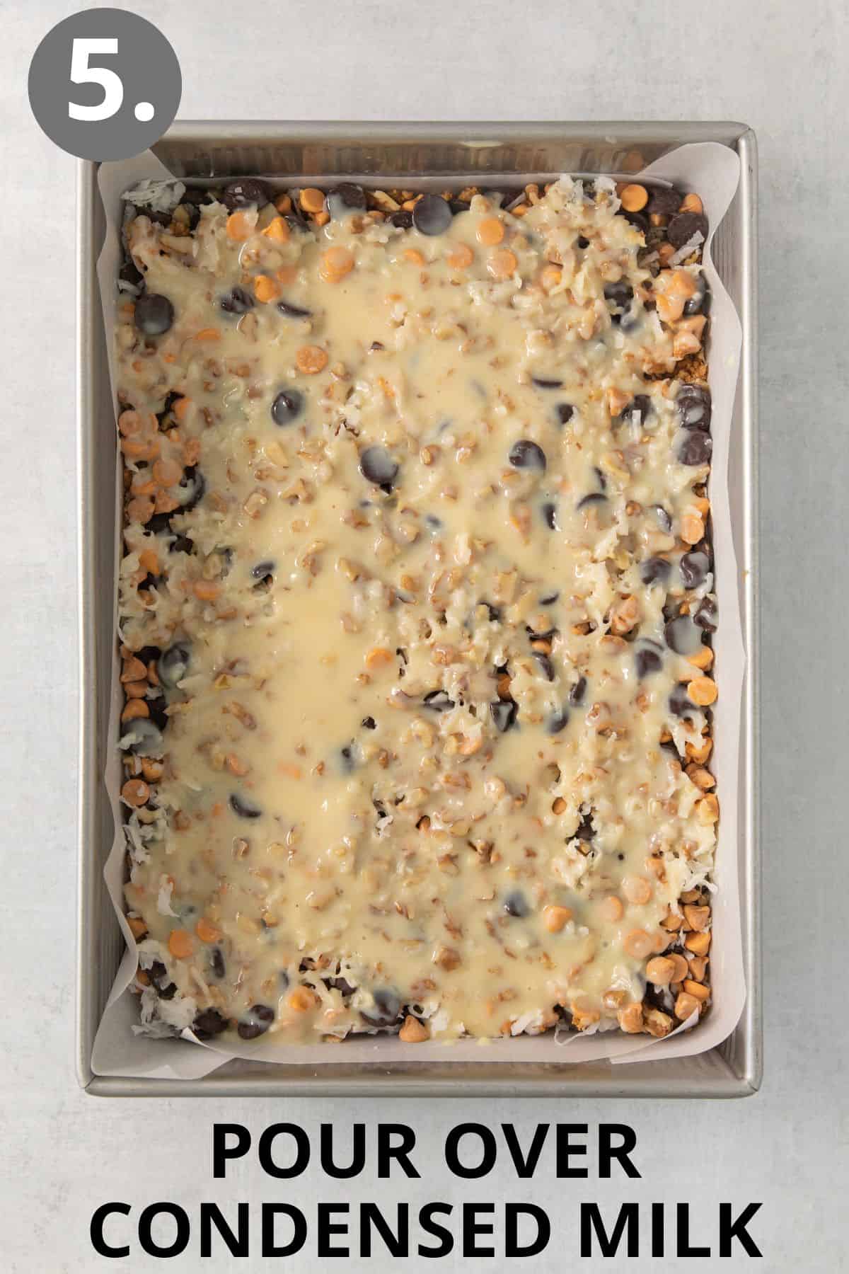 Condensed milk poured over the 7-layer bars