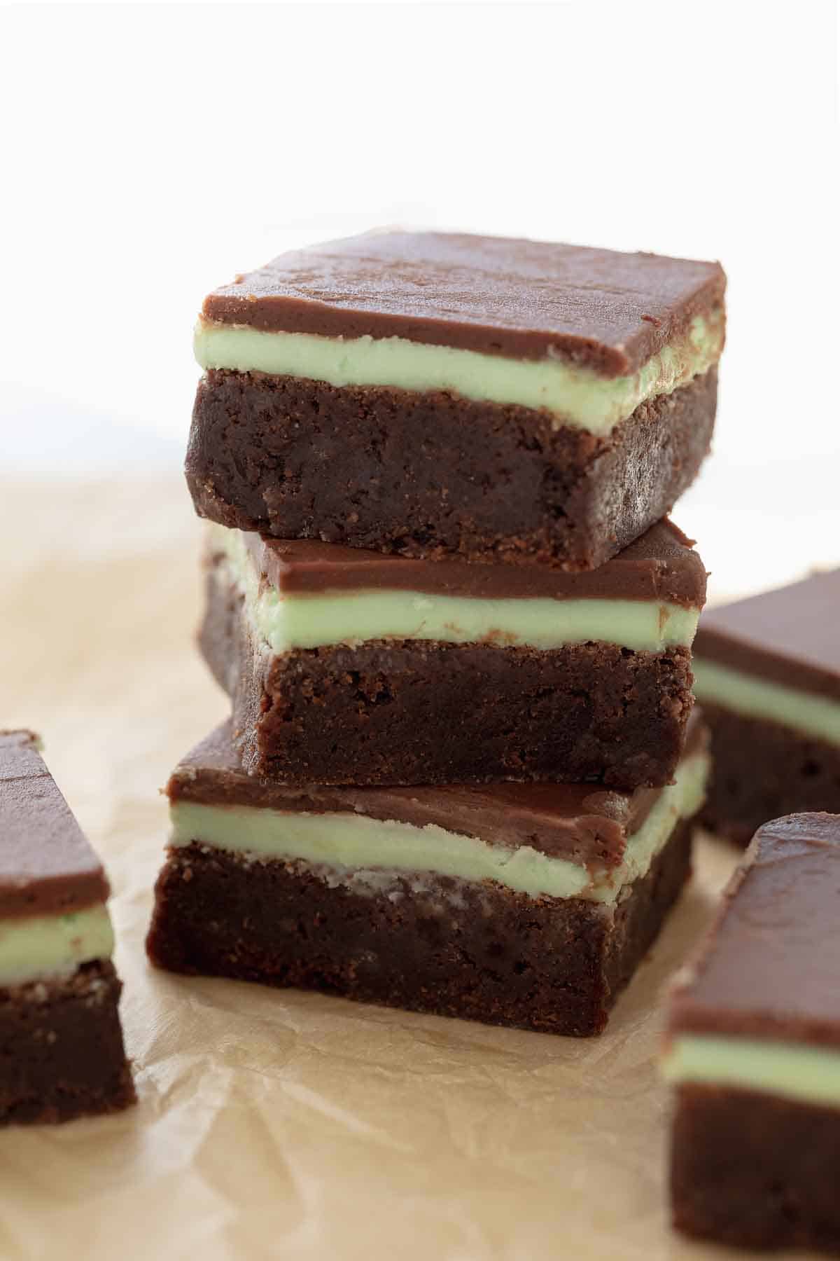 stack of gluten free mint brownies on brown parchment paper