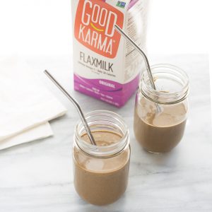 chocolate smoothie in glass jars with metal straw and Good Karma Flaxmilk