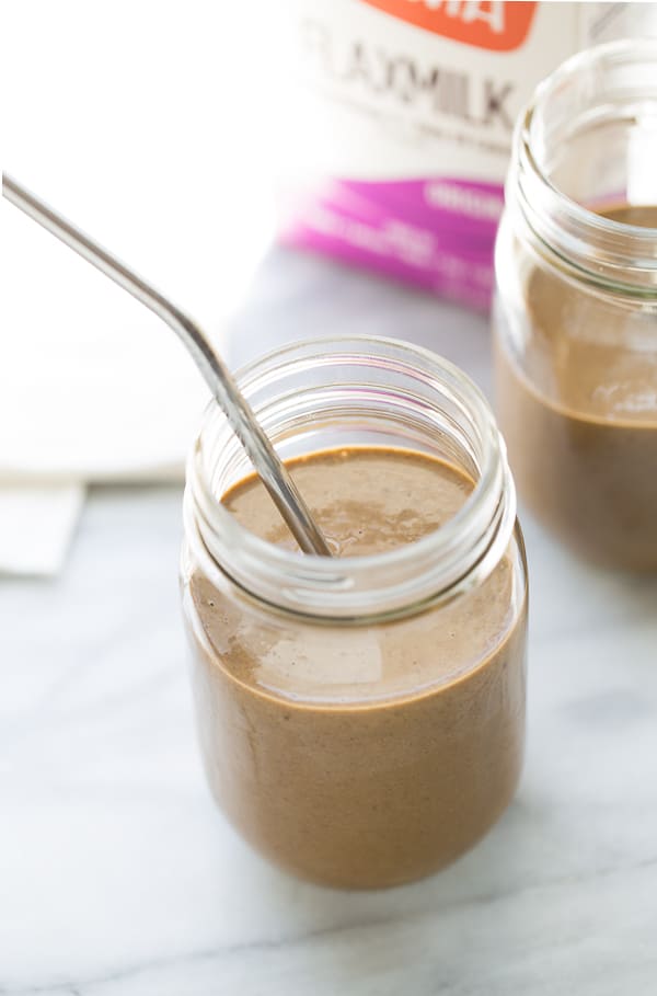 close up shot of chocolate smoothie in glass jars with metal straw and Good Karma Flaxmilk