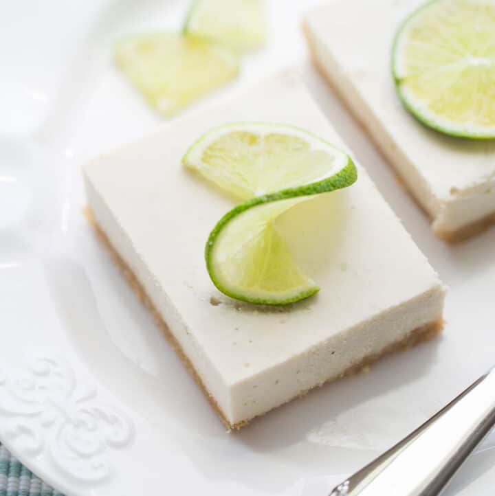 vegan key lime pie bars garnished with lime slices