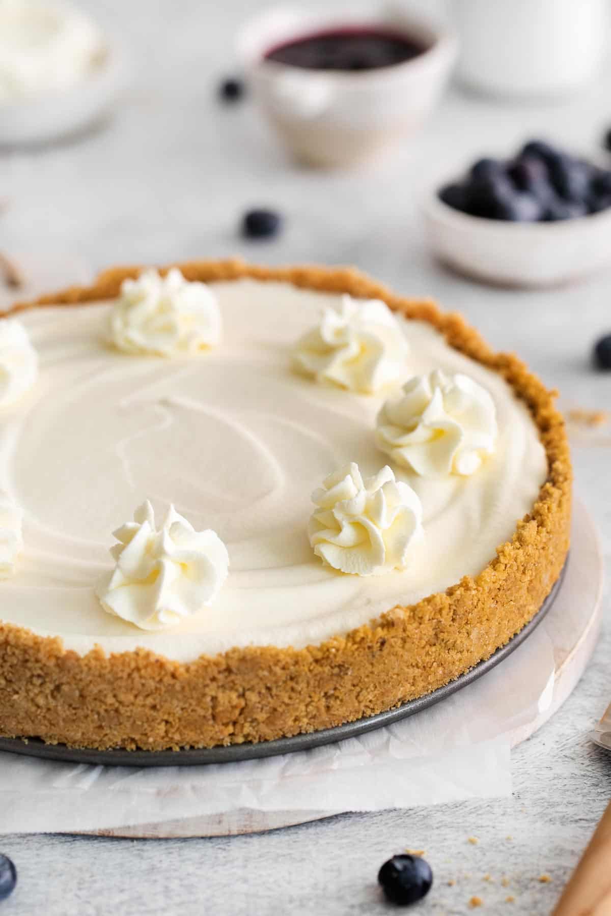 A whole gluten-free no-bake cheesecake on a serving dish