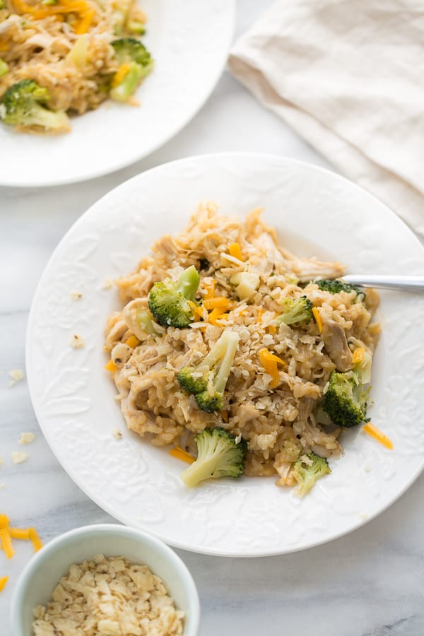 Instant Pot Chicken Broccoli and Rice in white bowls on a counter