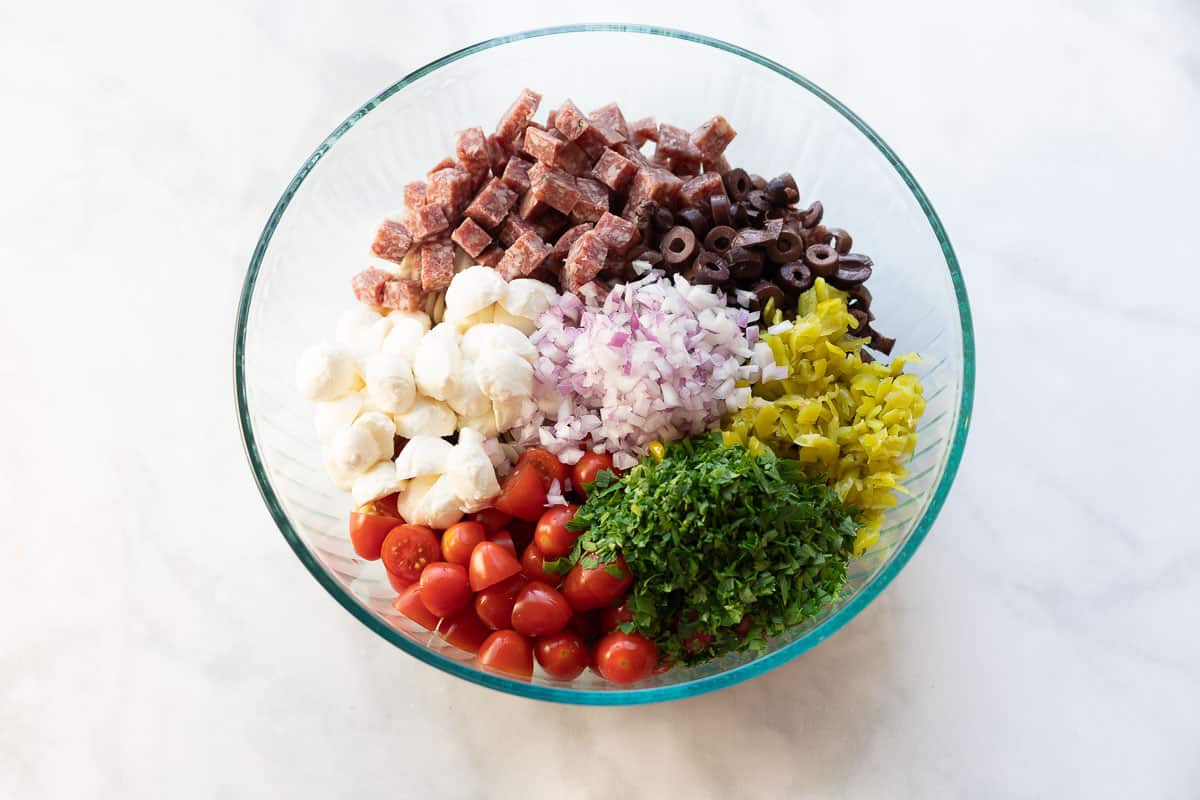 Pasta salad ingredients placed in a bowl together