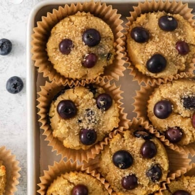 A close-up photo of coconut flour blueberry muffins in a baking dish