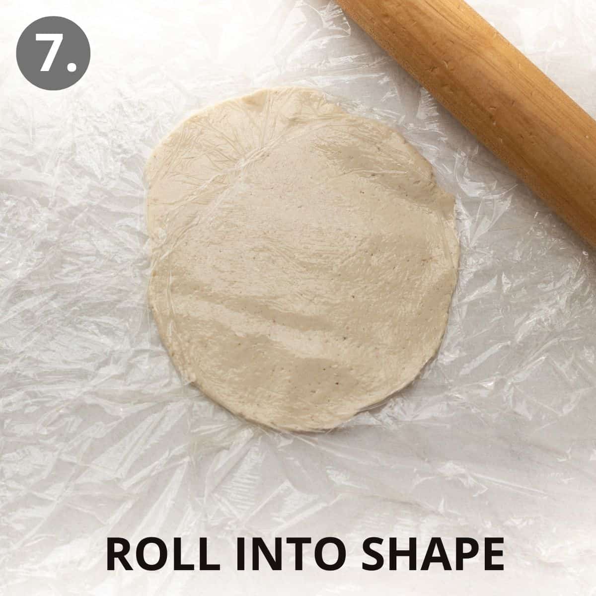 A piece of flatbread dough rolled out into a flat circle