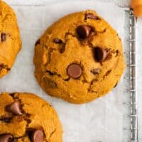 A close-up photo of a pumpkin chocolate chip cookie