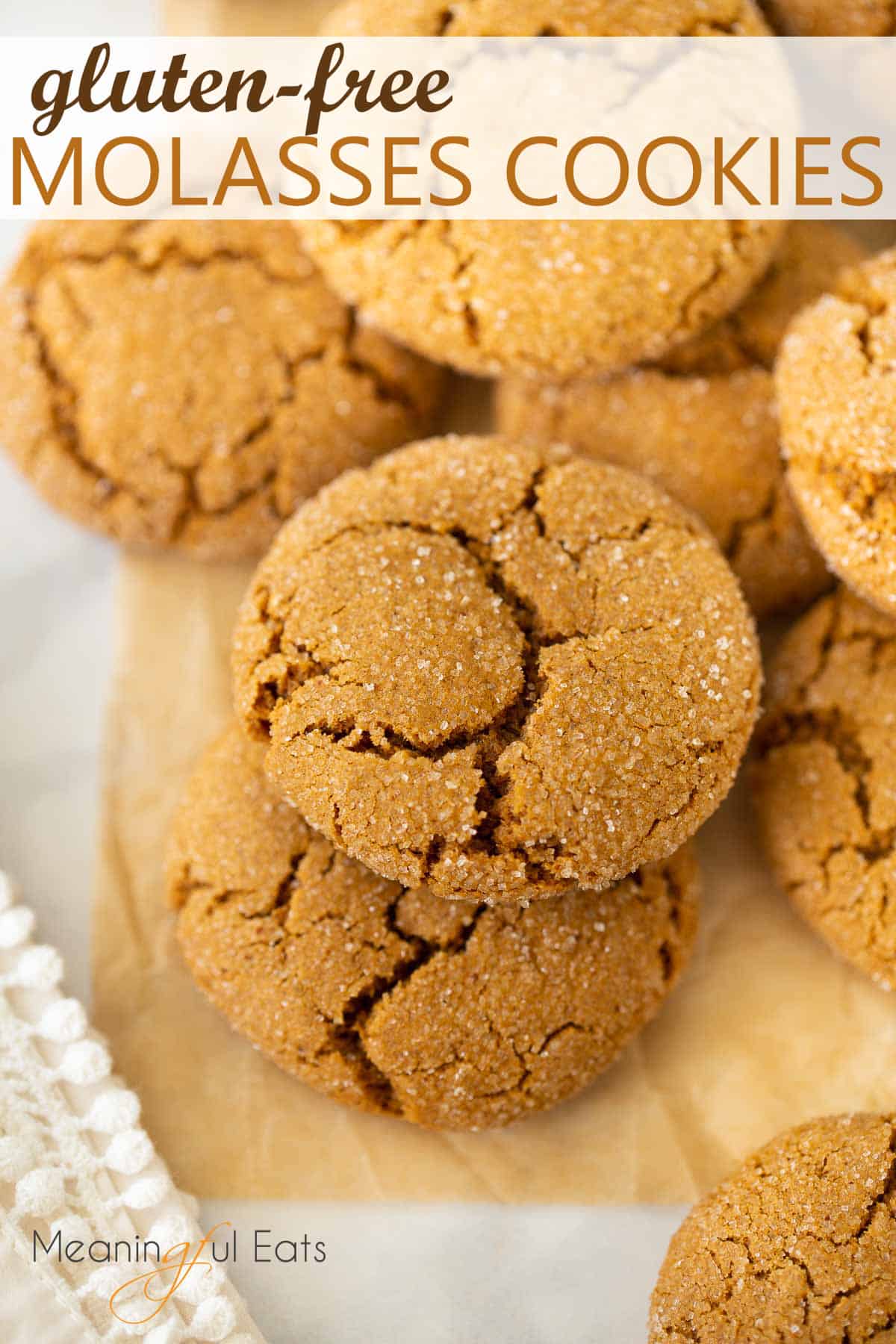 image for pinterest of molasses cookies stacked on brown parchment