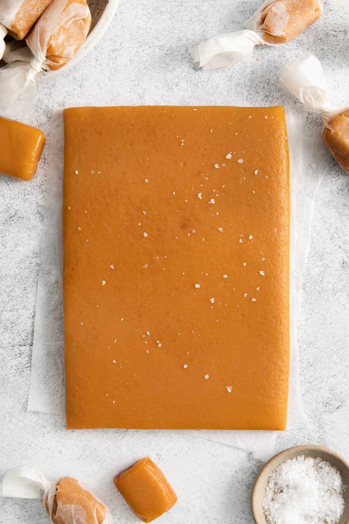 An overhead view of a slab of caramel, before cutting