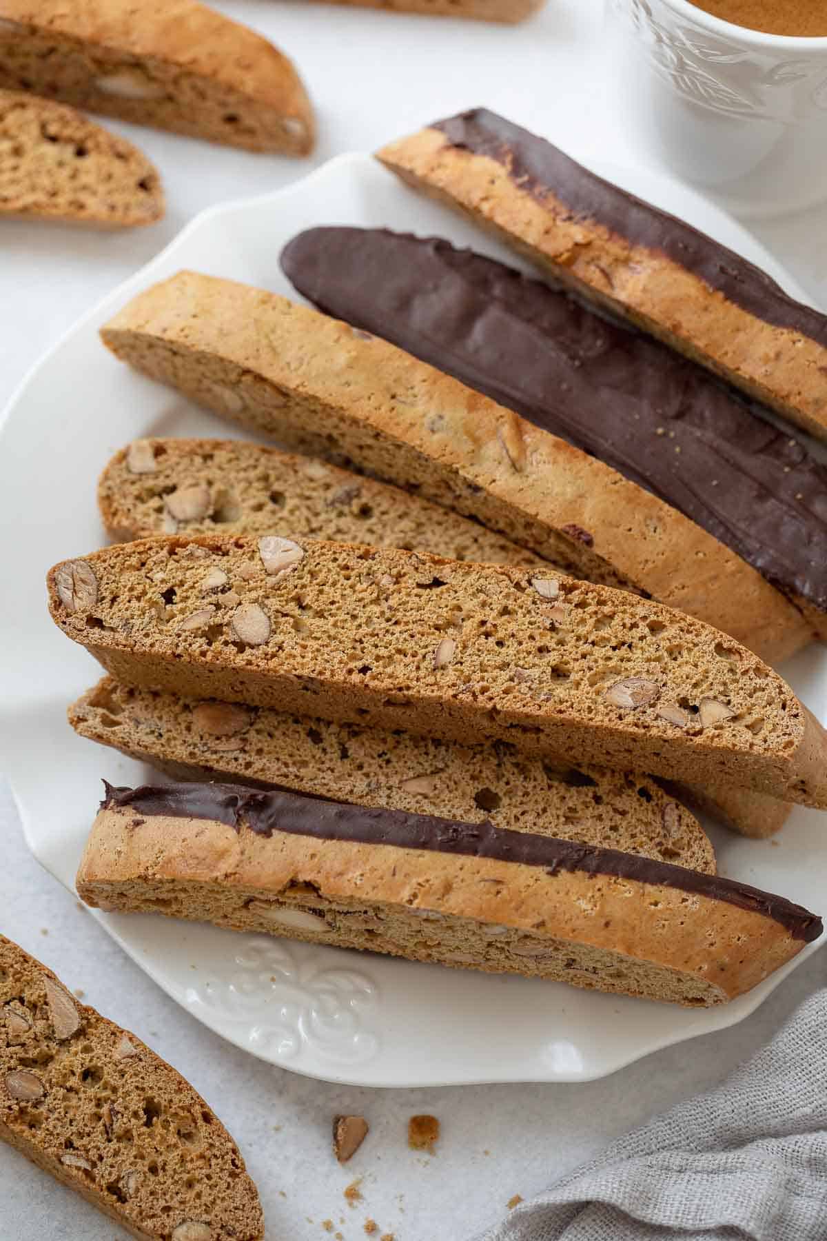 gluten free biscotti on a white plate coated in chocolate