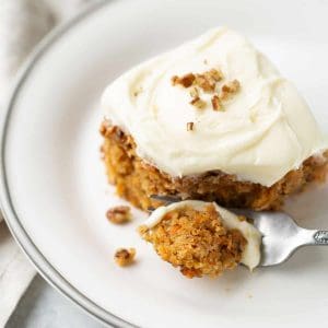 carrot cake on white plate with fork