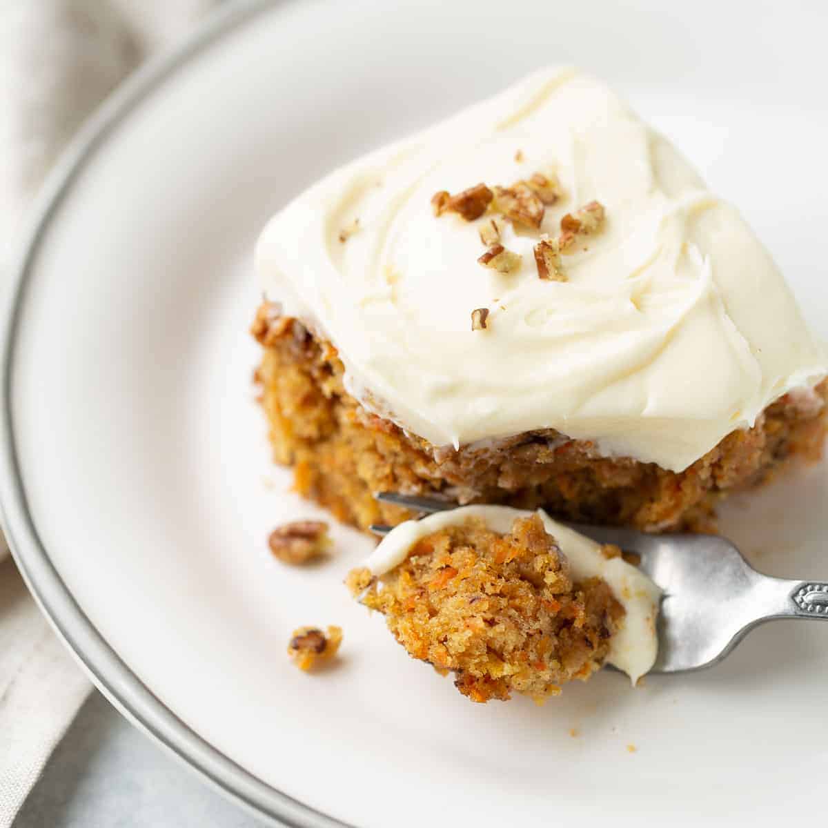 carrot cake on white plate with fork