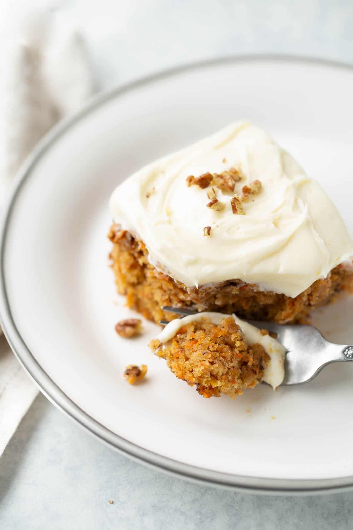 bite of carrot cake on plate with fork