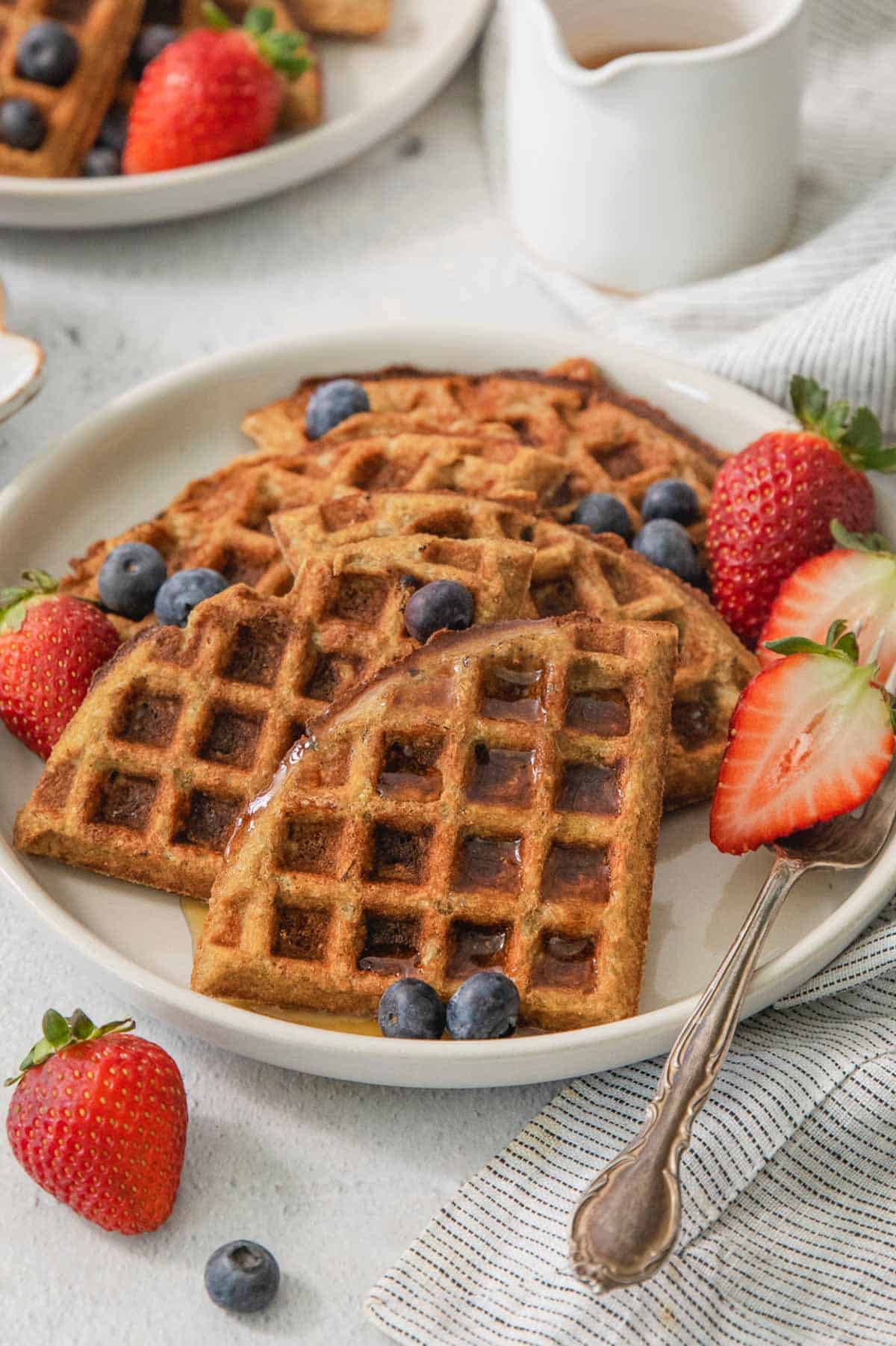 close up of buckwheat waffles on a plate with berries
