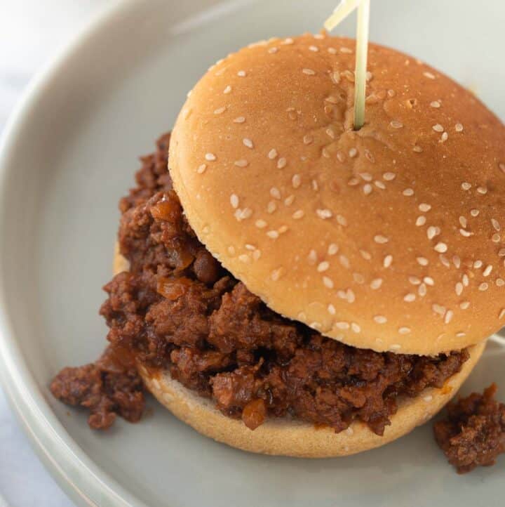 close up shot of sloppy joe to show texture of meat on gray plate