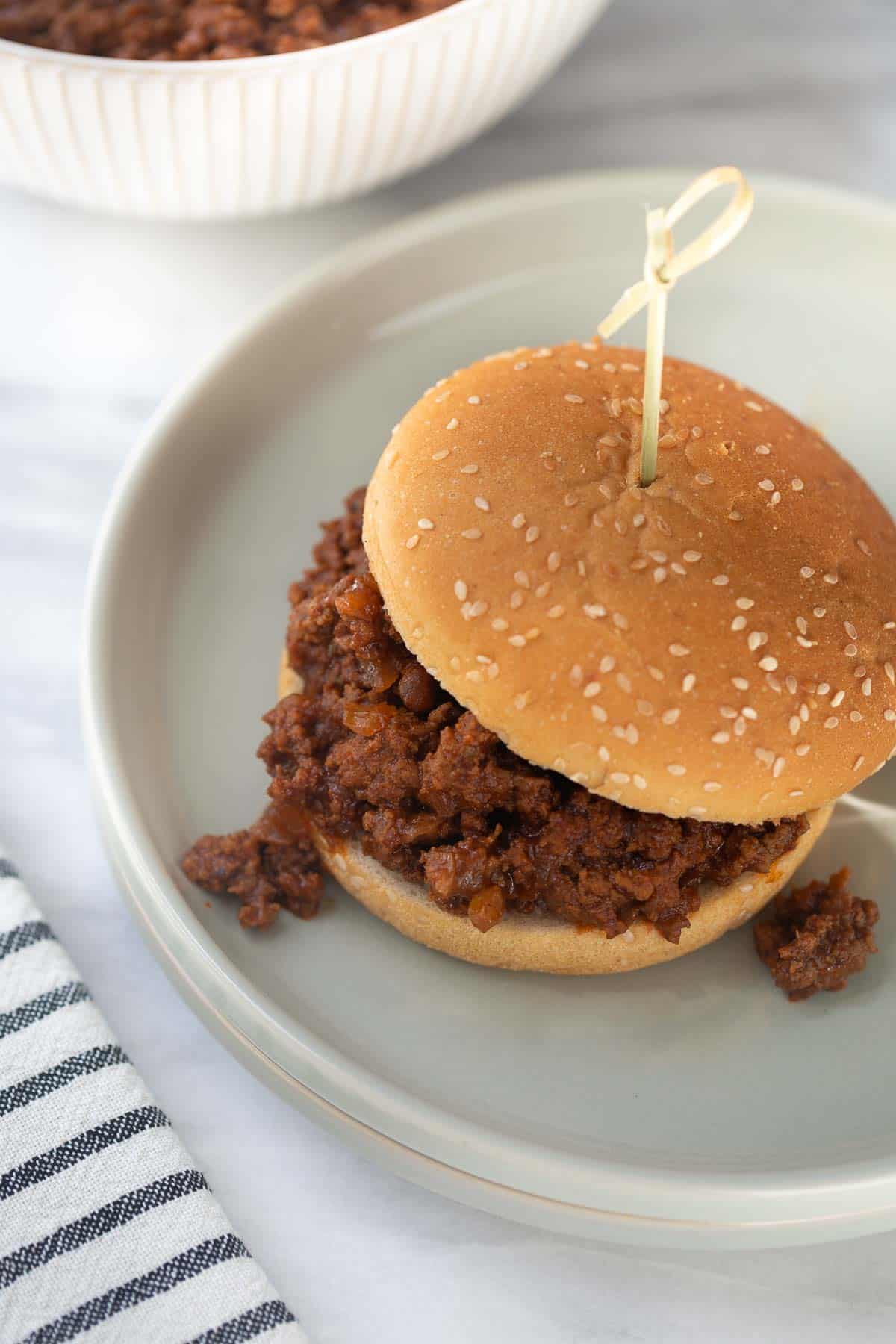gluten-free sloppy joe on bun with gray plate and marble background