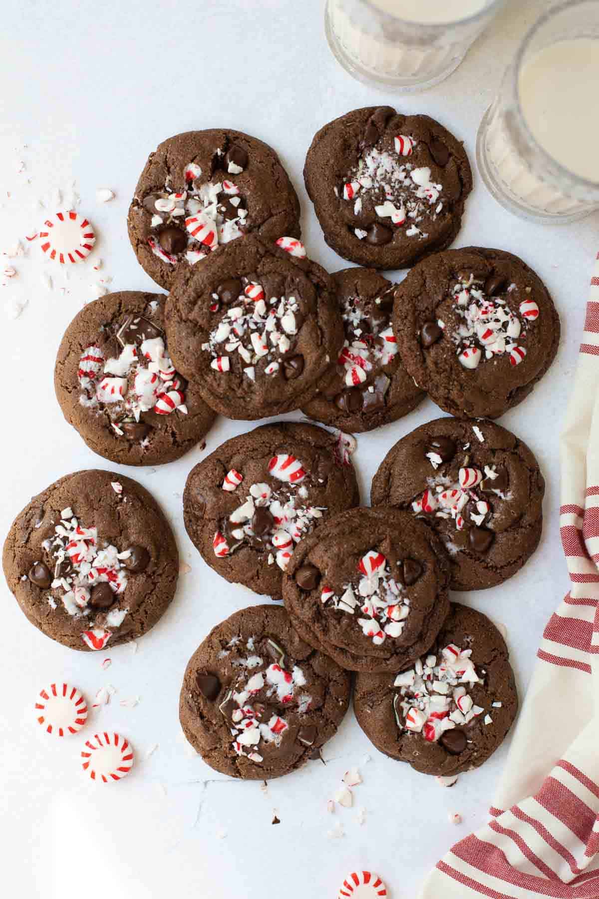 overhead shot of chocolate cookies with peppermint candy and red and white napkin